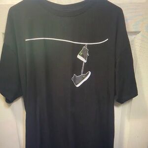 Black Graphic Tee with Hanging Sneakers